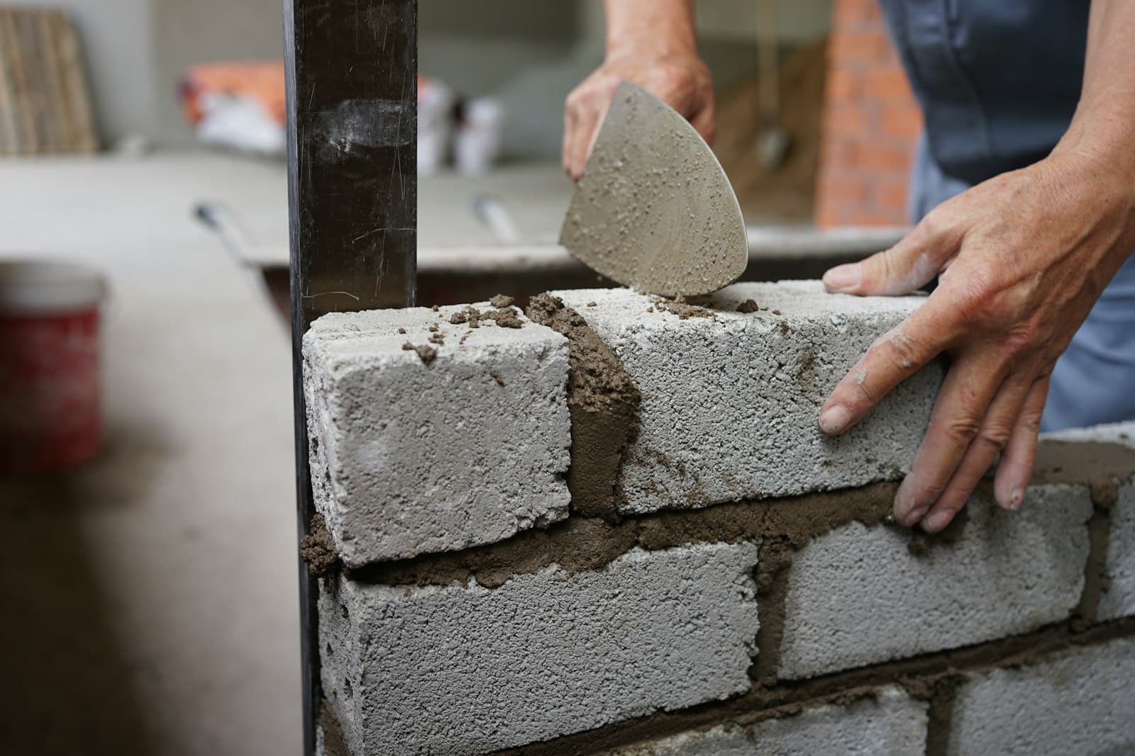 Mason laying block with a trowel
