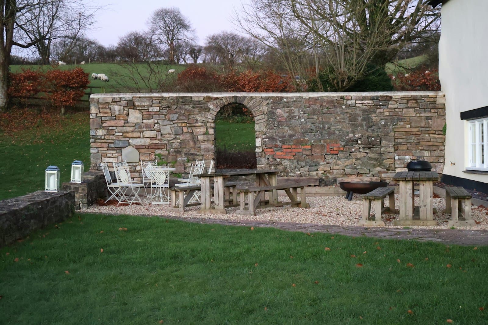 Outdoor patio with a stone wall and furniture